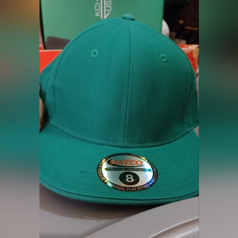Green fitted hat branded by Hatco
